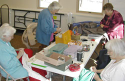 Women's group repairs coats for donation